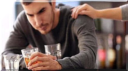 Alcoholic drinks with a person's hand on his shoulder