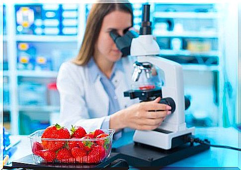 Woman examining pesticides at the microscope