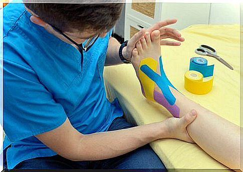 Physiotherapist puts bandage on the foot